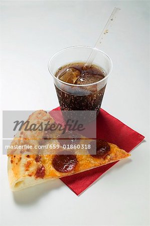 Slice of American-style pepperoni pizza with cola