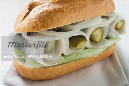 Herring, onions and gherkins in bread roll