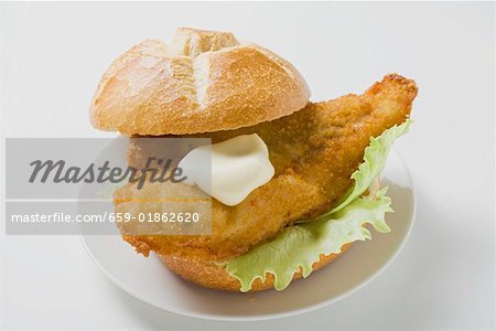 Breaded fish fillet and mayonnaise in bread roll