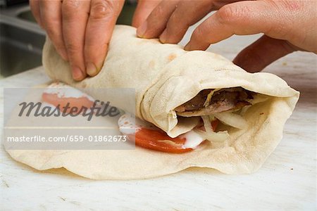 Making a döner wrap (rolling up)