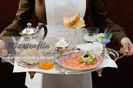 Chambermaid serving luxury breakfast tray