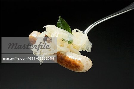 Sausage with sauerkraut on fork