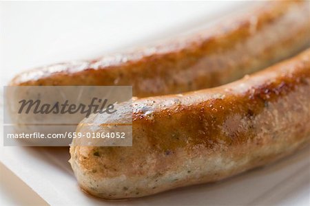 Two sausages (bratwursts) on paper plate (close-up) Two sausages (bratwursts) on paper plate (close-up)