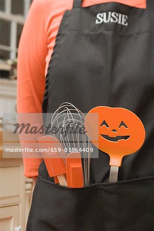 Kitchen tools for Halloween in an apron pocket