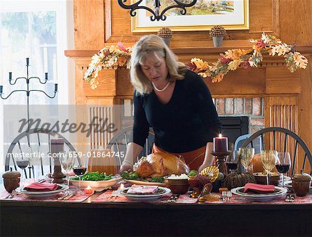 Woman serving stuffed turkey for Thanksgiving (USA)