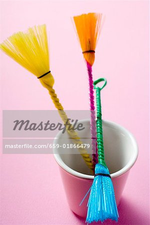 Three coloured pastry brushes in pink beaker