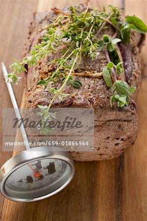 Roast beef with herbs, meat thermometer