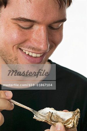 Man eating a fresh oyster