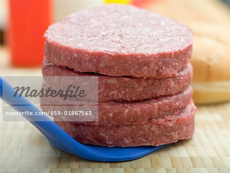 Four raw burgers for hamburgers
