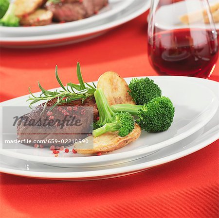 Beef steak with pink peppercorns and vegetables