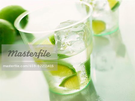 Mineral water with pieces of lime and ice cube