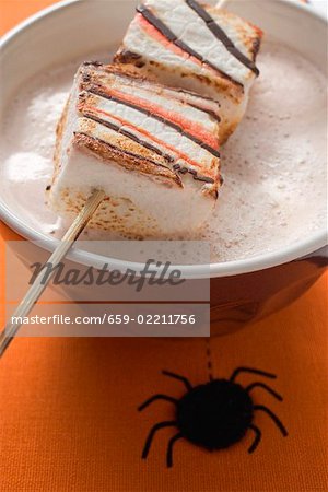 Cocoa with marshmallows on stick for Halloween