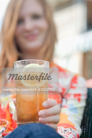 Woman holding a glass of iced tea