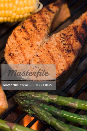 Salmon steak and vegetables on a barbecue