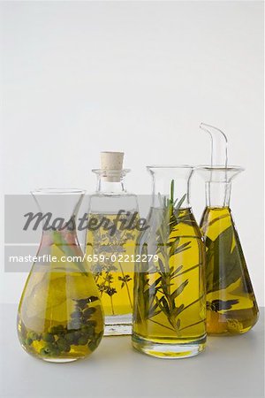 Four different herb oils in bottles