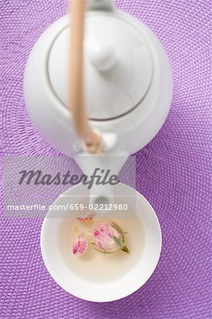 Teapot and bowl of rose tea