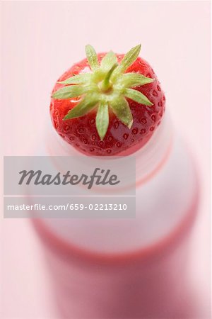 Strawberry drink in plastic bottle (overhead view)