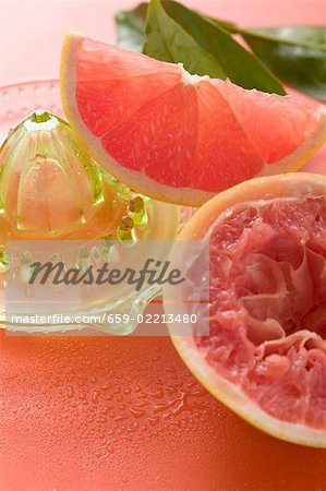 Pink grapefruit wedge, squeezed grapefruit, citrus squeezer