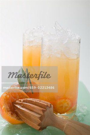 Citrus fruit and crushed ice in two tall glasses