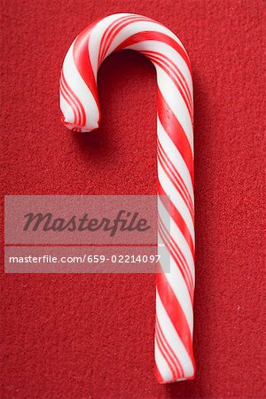 Candy cane on red background