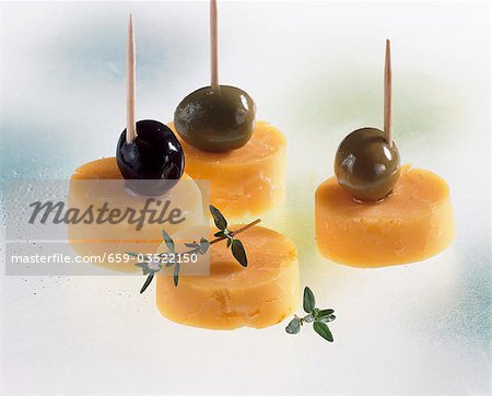 Cheddar cheese and olives on cocktail sticks
