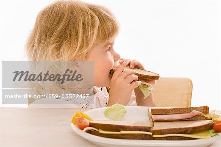 Little girl eating sandwich