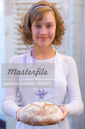 Girl holding bread she has baked herself