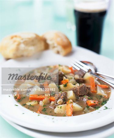 Irish stew with bread and a glass of Guinness