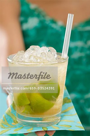 Woman holding glass of Caipirinha Woman holding glass of Caipirinha