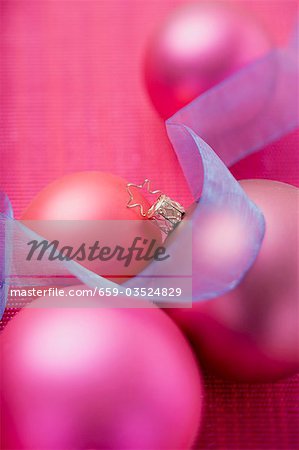 Pink Christmas baubles with blue ribbon