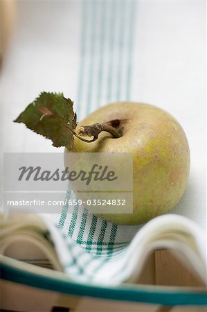 An organic apple on a tea towel