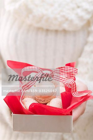 Woman holding box of Christmas biscuits