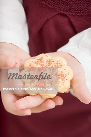 Small girl holding a Christmas biscuit