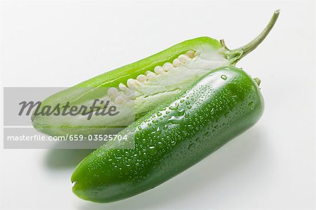 Green chilli with drops of water, halved