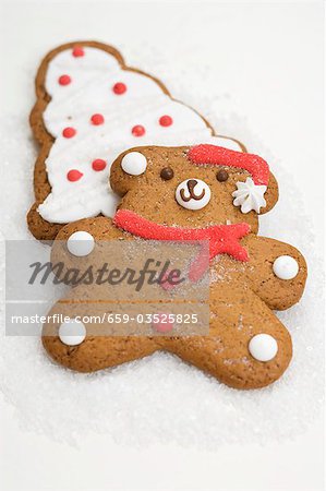 Two Christmas biscuits (teddy bear & Christmas tree) on sugar