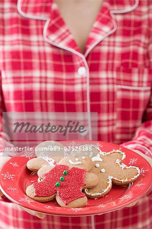 Woman holding plate of gingerbread men