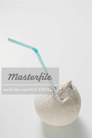 Shelled coconut with straw