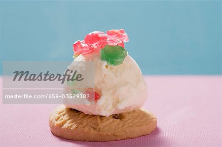 Scoop of ice cream with peppermints on cookie