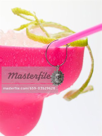 Frozen Margarita with lime zest in pink glass Frozen Margarita with lime zest in pink glass