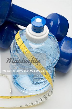 Bottle of water, hand weights and tape measure