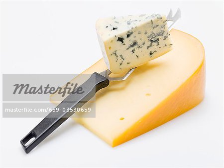 Pieces of Gouda and Gorgonzola with cheese knife