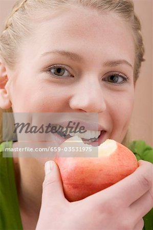 Woman holding partly eaten apple