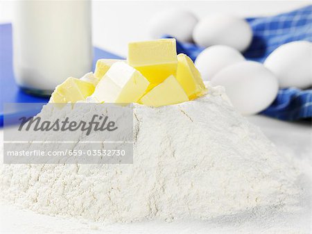 Heap of flour with cubes of butter