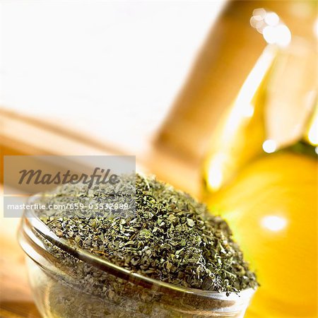 Dried chopped oregano in a glass dish Dried chopped oregano in a glass dish