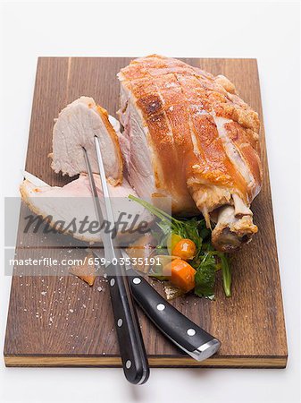 Roast pork on wooden board