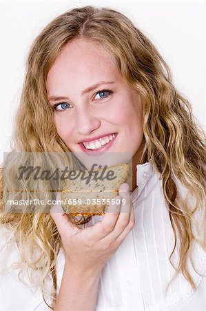 Young woman with a slice of grannary bread