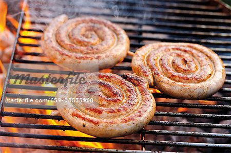 Coiled sausages on barbecue rack