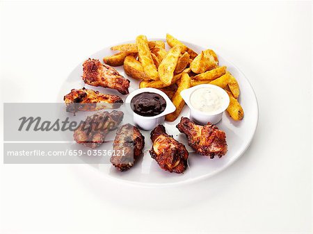 Barbecue chicken wings with potato wedges and dips