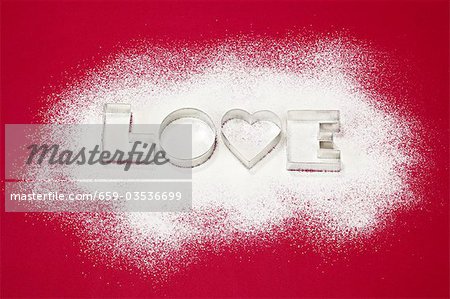 Biscuits cutters for 'LOVE' biscuits on icing sugar