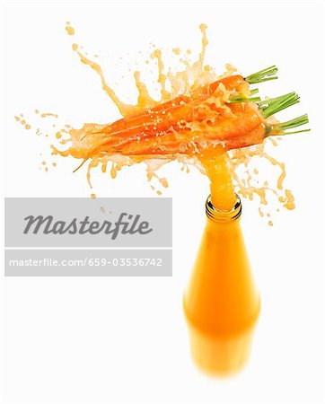 Download Carrot Juice Splashing Out Of Bottle Stock Photo Masterfile Premium Royalty Free Code 659 03536742 PSD Mockup Templates